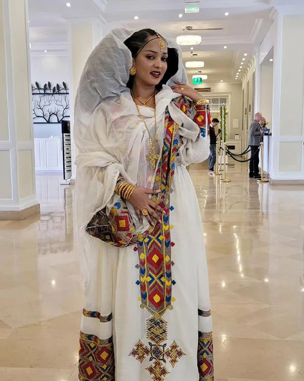Eye-Catching Habesha Kemis: Multicolored Habesha Dress with a Colorful Hemline