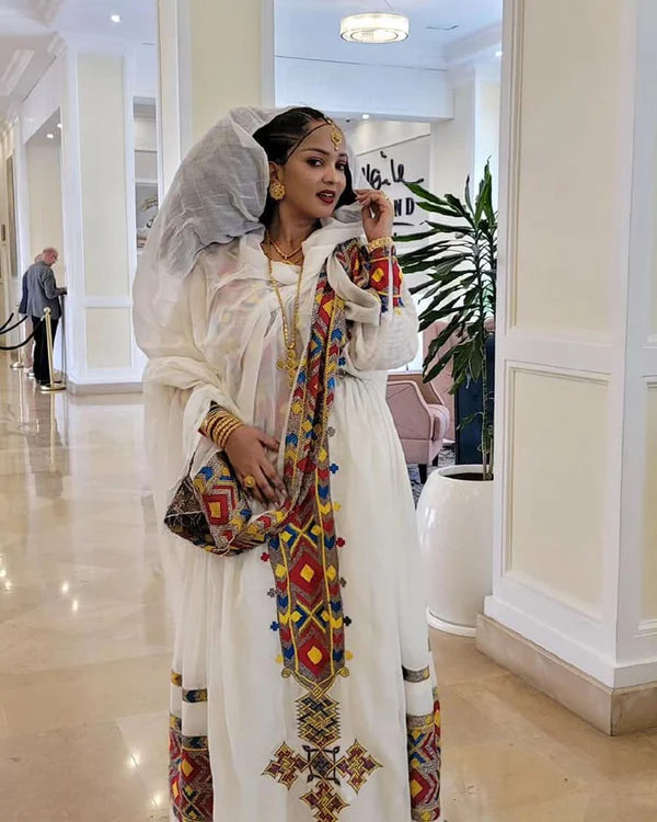Eye-Catching Habesha Kemis: Multicolored Habesha Dress with a Colorful Hemline